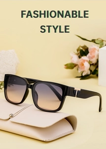 Detail of square black sunglasses with gradient lenses and T-shaped metal hinges