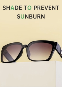 Macro detail of black oversized square sunglasses with gold metal hinge accents