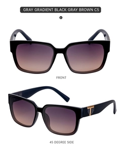 Macro view of square black sunglasses with purple gradient lenses and gold T-hinge detail