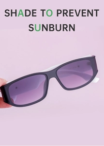 Detail of square sunglasses with purple gradient lenses and contrasting white temples