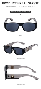 Detail view of square black sunglasses with gold logo on translucent gray temples