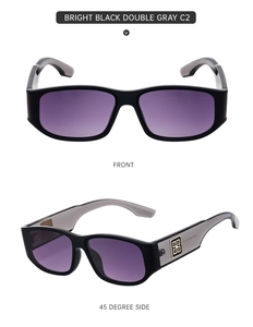 Detail view of black square sunglasses with purple gradient lenses and gold temple relief