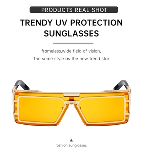 Detail of yellow transparent lenses and gold metal frames on square tech sunglasses