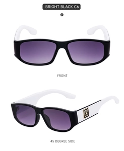 Close-up of bright black frame sunglasses with white temples and golden square logo detail
