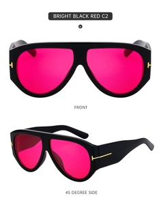 Detail view of black frame sunglasses with red lenses and golden T-shaped metal hinges