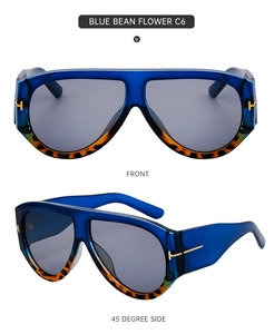 Detail view of blue and tortoise frame sunglasses with golden T-shaped metal accents