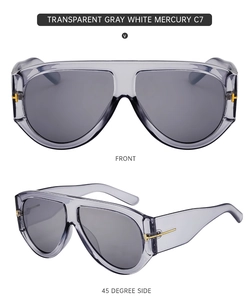 Close-up of transparent gray shield sunglasses with golden T-shaped metal hinges