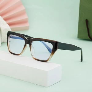 Chic cat-eye blue light blocking glasses with a brown gradient frame on a white stand