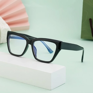 Stylish black cat-eye blue light blocking glasses on a decorative minimalist display