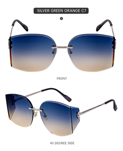 Close-up of rimless sunglasses with blue-orange gradient lenses and silver metal frames