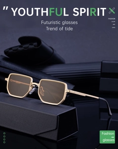 Detail of square gold metal sunglasses with brown lenses on a dark leather case