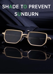 Detailed close-up of square metal sunglasses with gold frames and leather pouch