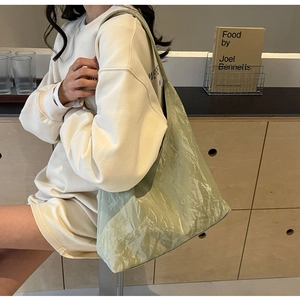 Detail of light green minimalist tote bag with unique crinkled texture and spacious interior