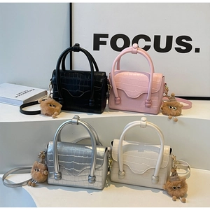 Selection of crocodile pattern mini handbags in black, pink, silver and white with bear charms