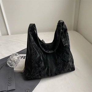 Chic black textured hobo bag with large capacity and elegant minimalist shoulder strap