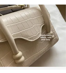 Detail of cream stone pattern handbag showing the soft crocodile embossed texture