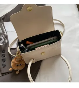 Interior view of off-white stone pattern bag with smartphone and lipstick storage