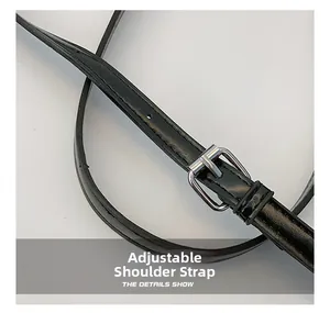 Close-up of adjustable black glossy leather shoulder strap with silver metal buckle detail