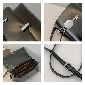 Detail of black faux leather bag showing interior zipper pockets and silver metal clasp
