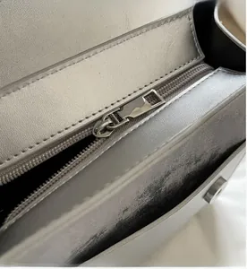 Detail shot of smooth silver metal zipper and stitching on the fashionable backpack