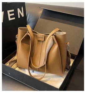 Brown leather tote bag detail with vintage ethnic strap and premium gift box set