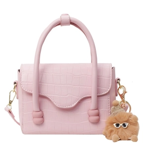 Pink stone pattern shoulder bag with curved handle and plush monster charm on white background