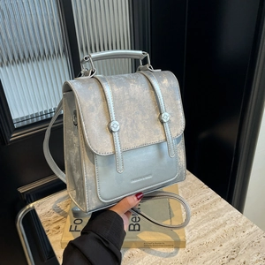 Silver-grey faux leather backpack with metallic finish and top handle for women