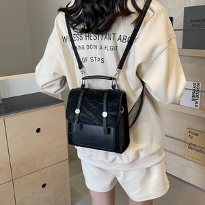 Versatile black aesthetic backpack for women featuring glossy and matte leather textures