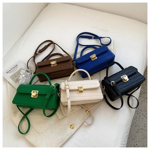 Flat lay of small crossbody bags in various colors with crocodile stone pattern