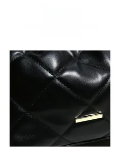 Detail of black quilted leather texture with premium golden metallic buckle