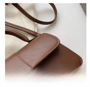 Detailed macro view showing the precise stitching on a high-quality brown leather handbag
