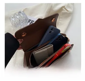 Detail view of brown crossbody bag interior showing spacious compartments for daily items