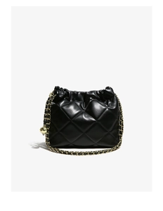Close-up of black quilted leather bucket bag with gold chain strap and drawstring detail