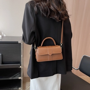 Chic mocha brown leather handbag for women featuring gold hardware and a shoulder strap