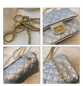 Detail of silver quilted leather texture with gold-tone chain strap and metal lock