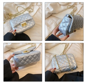 Detail view of silver quilted leather bag with gold clasp and chain strap