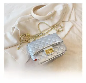 Detail of silver quilted leather bag with gold-tone chain strap and classic twist lock