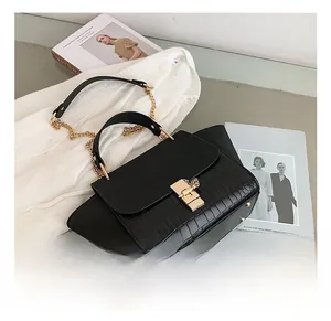 Detail showing black crocodile texture faux leather bag with golden square metal buckle