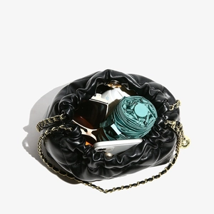 Quilted black leather bucket bag with gold chain strap and large interior capacity