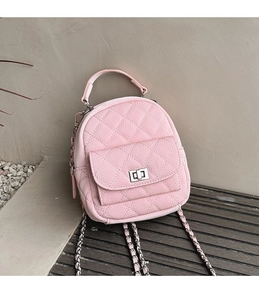 Detailed view of pink pebble leather mini backpack with quilted pattern and chain strap