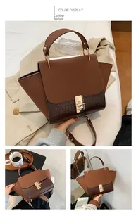 Detail of coffee brown crossbody bag with matte flap and crocodile pattern side wings