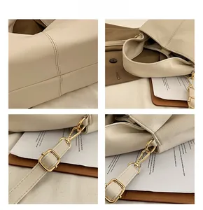 Close-up of litchi texture PU leather, fine stitching, and golden hardware on tote bag