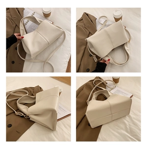 Detail views of cream off-white pebbled leather handbag with adjustable strap and stitching