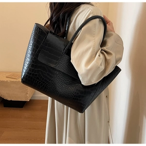 Detail of black faux leather tote bag with embossed stone texture and large capacity