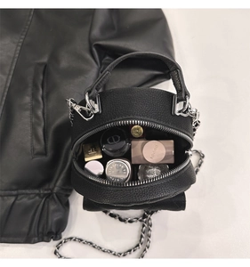 Top view of black pebbled leather cylinder bag showing interior storage capacity