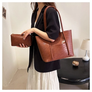 Detail of caramel brown crocodile embossed tote bag set with matching inner clutch bag