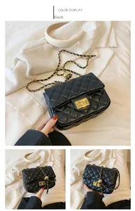 Detailed close-up of a black quilted leather bag featuring a gold metal twist lock
