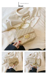 Detail view of khaki quilted crossbody bag with gold chain and square twist lock