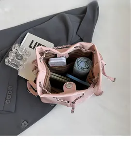 Top view of pink bucket bag interior showing large capacity for essentials and striped lining