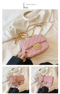 Detail of pink quilted leather bag featuring golden chain strap and adjustable ball charm